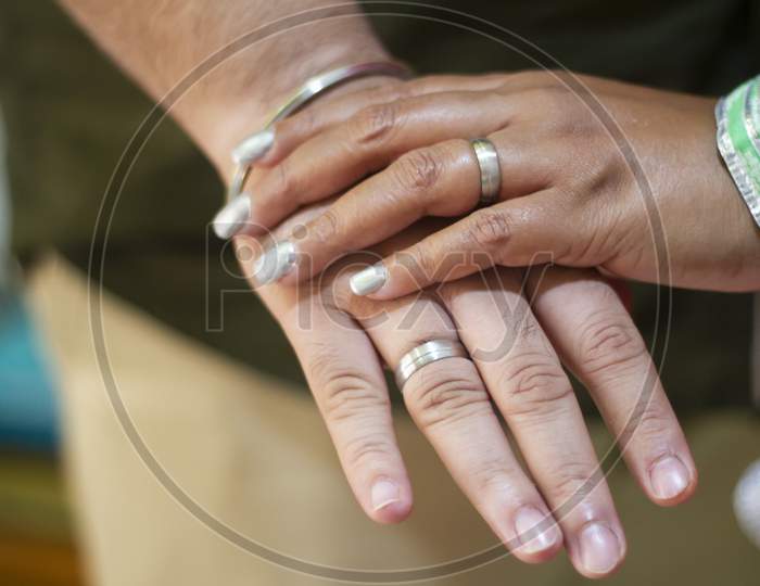 Picture Of Man And Woman With Wedding Ring.Young Married Couple Holding Hands, Ceremony Wedding Day. Newly Wed Couple'S Hands With Wedding Rings.
