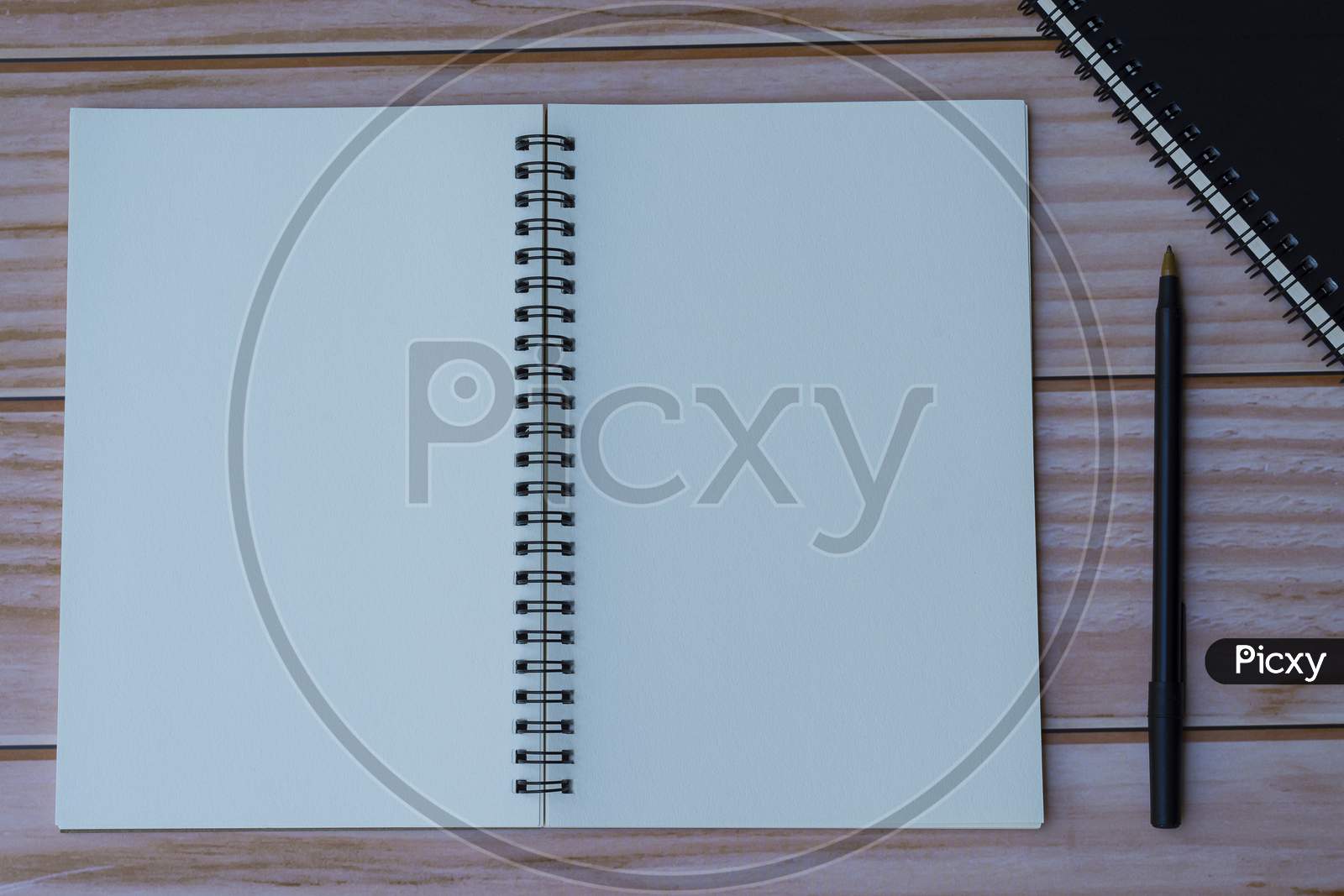 Notepad With Pen On Wooden Background