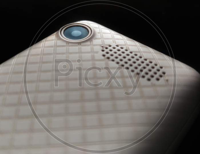 Old mobile phone rear camera and speaker with isolated background