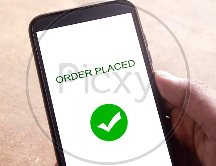 Order placed on a smartphone, hand holding smartphone
