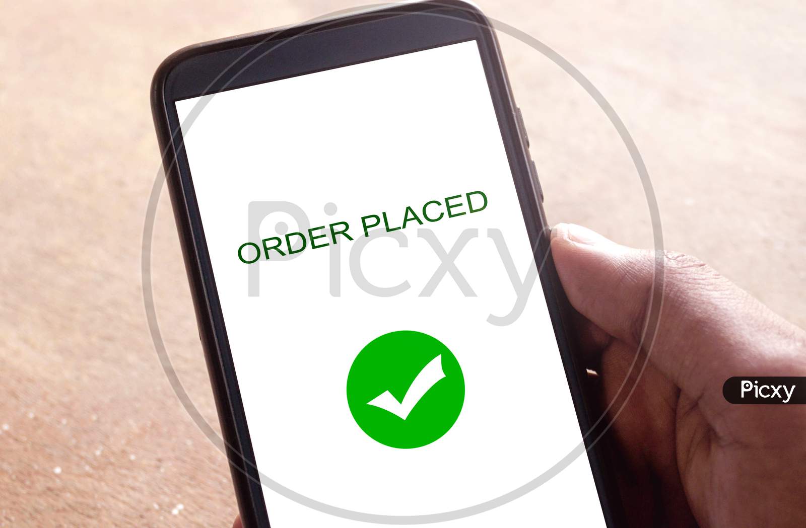 Order placed on a smartphone, hand holding smartphone