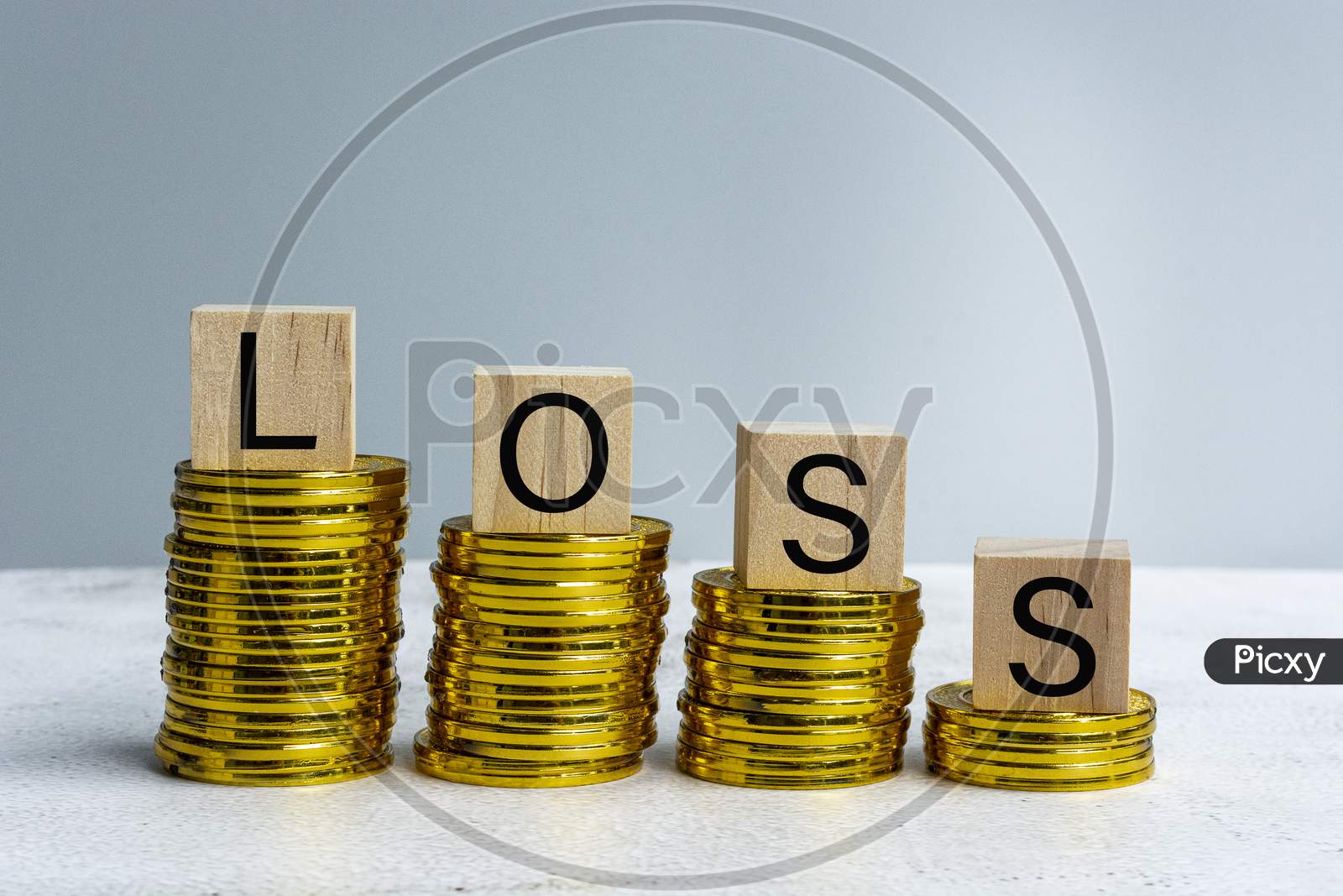 Loss Text On Wood Block With A Pile Of Coins
