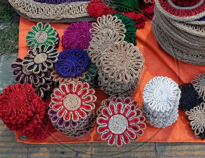 Beautiful Handmade Coasters And Doormats Made By Jute Is Displayed In A Shop For Sale In Blurred Background. Indian Handicraft
