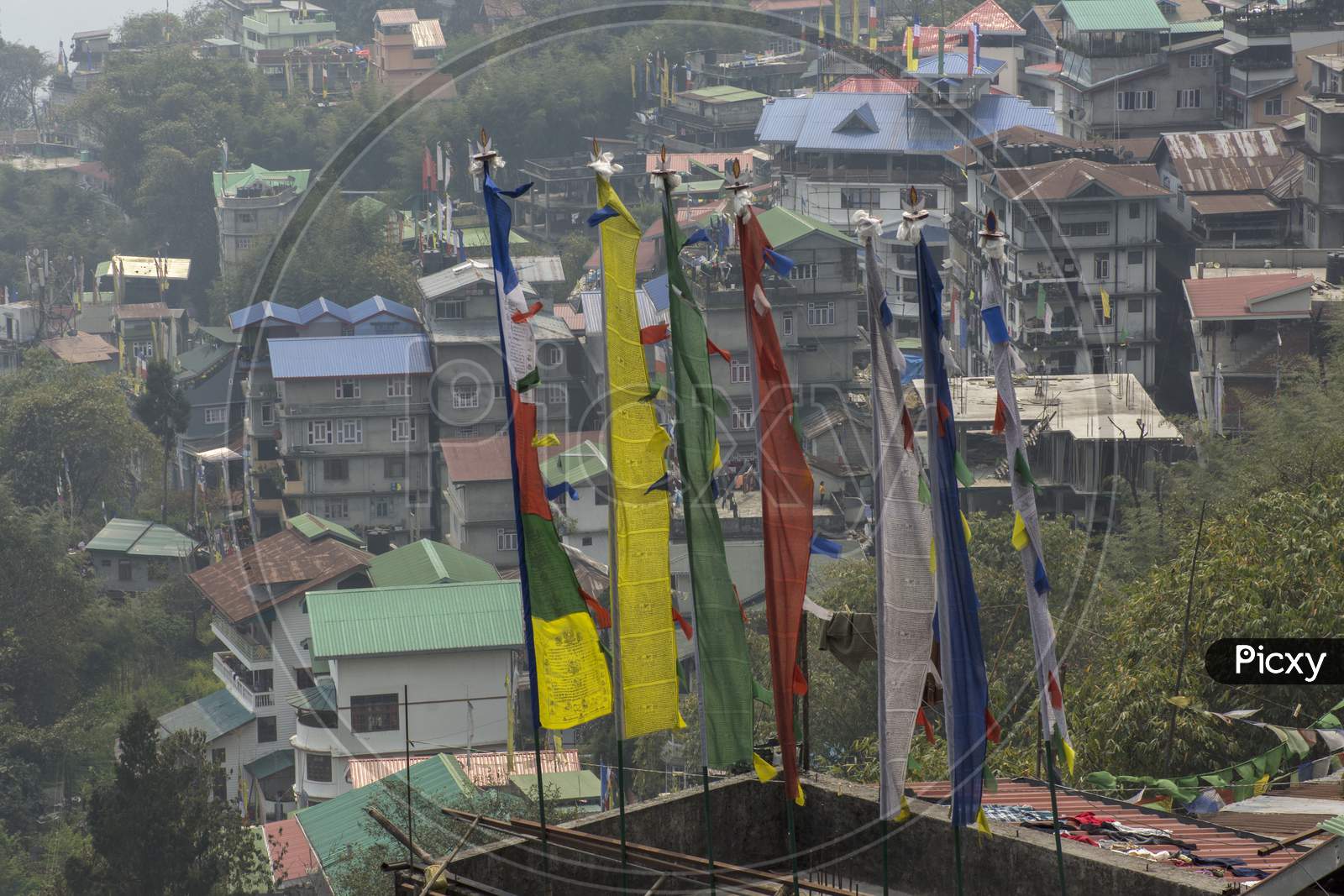 Multicolored Prayer Flags And Gangtok City In Background.