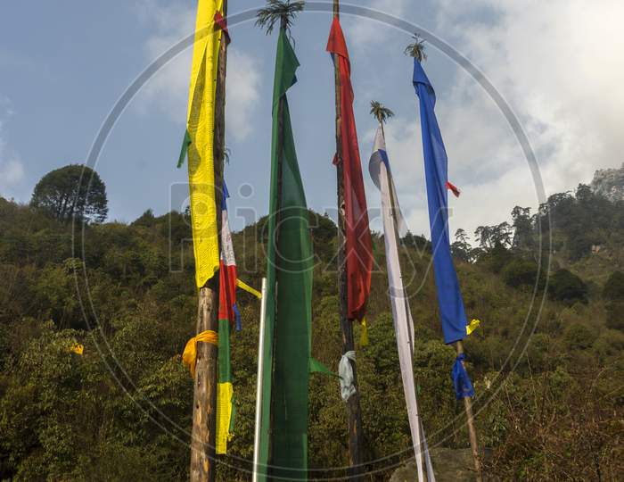 Multicolored Prayer Flags And Beautiful Green Mountain In Background.