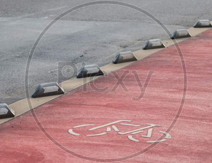 Safety in road traffic for bicycles and bikers by bike way protection and car guidance systems on the red lane for cyclists shows biking friendly city streets for sustainable mobility and ecology