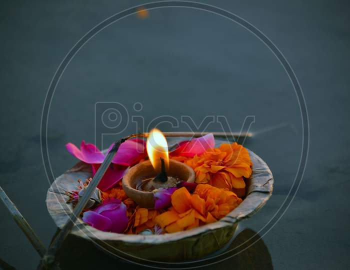 clay lamp and flowers in water rituals of Indian culture