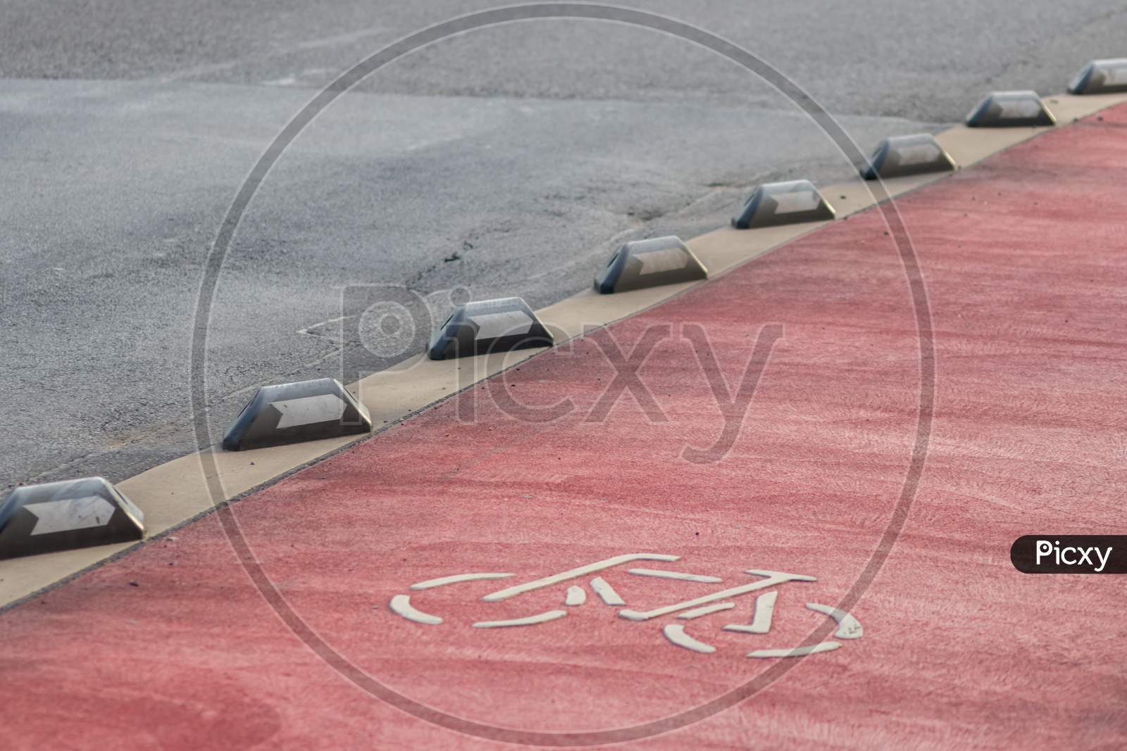 Safety in road traffic for bicycles and bikers by bike way protection and car guidance systems on the red lane for cyclists shows biking friendly city streets for sustainable mobility and ecology