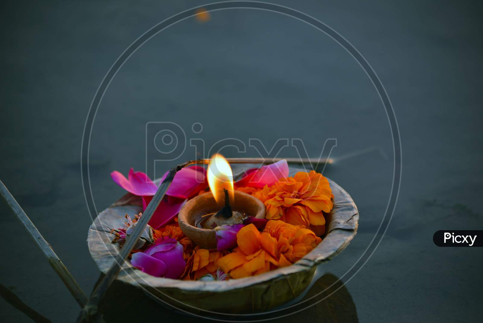 clay lamp and flowers in water rituals of Indian culture