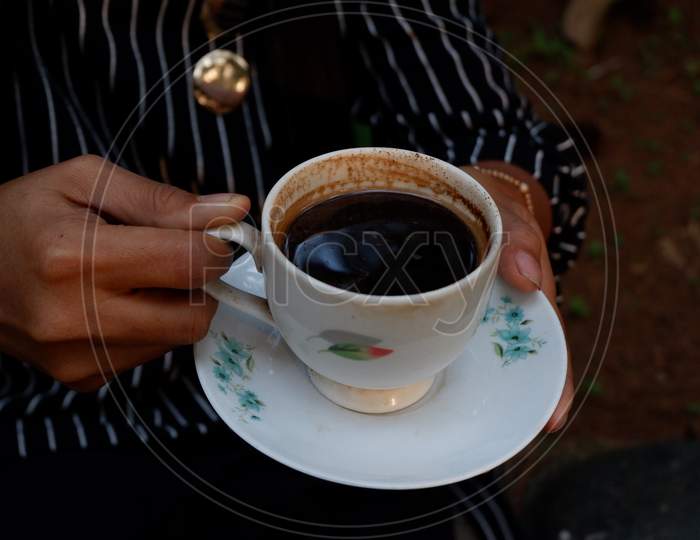 A Cup Of Black Coffee In An Ivory White Ceramic Cup