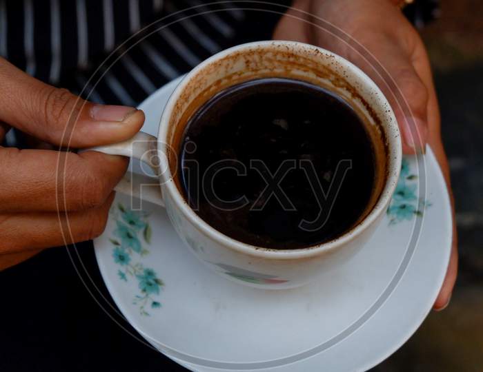 A Cup Of Black Coffee In An Ivory White Ceramic Cup