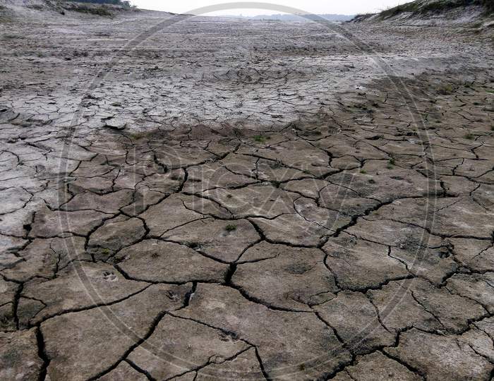 The River Is Drying Up. Detail Of Cracked Soil Or Earth After Drought Weather. Cracked Earth, Cracked Soil. Textures Of Soil Dry Cracking Parking Earth. The Effects Of Global Warming.