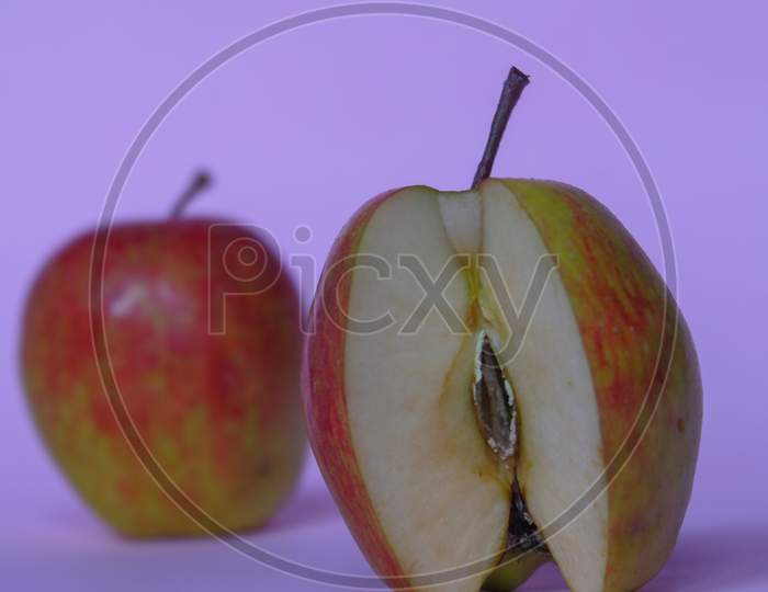 A Split Apple With A Pink Background, A Perfect Photo For A Food Flogger