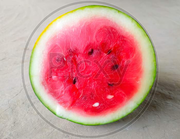 half of fresh watermelon isolated on gray background
