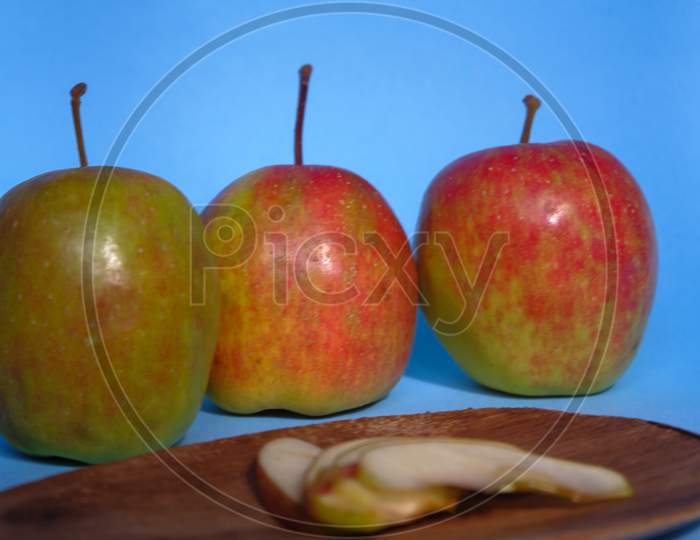 A Split Apple With A Blue Background, A Perfect Photo For A Food Flogger