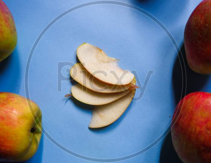 A Split Apple With A Blue Background, A Perfect Photo For A Food Flogger