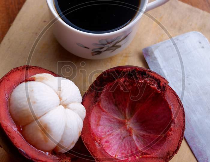 The Photo Is A Photo Of A Person Holding Mangosteen And Tea