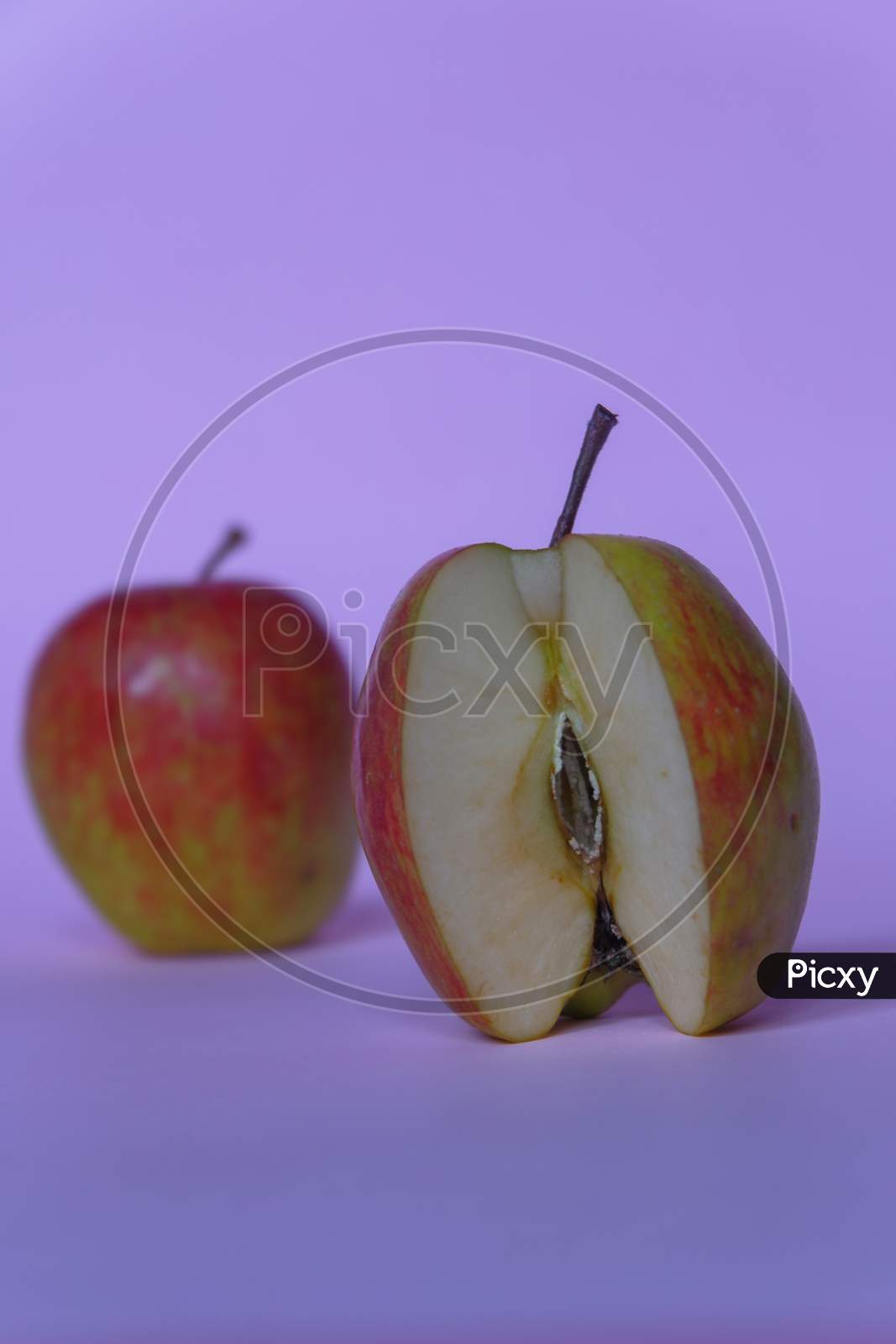 A Split Apple With A Pink Background, A Perfect Photo For A Food Flogger