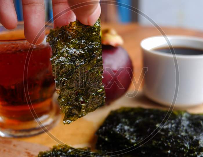 Photo Of Chopped Seaweed And A Cup Of Coffee And Mangosteen Beside It, A Photo Of The Meaning Of The Drink