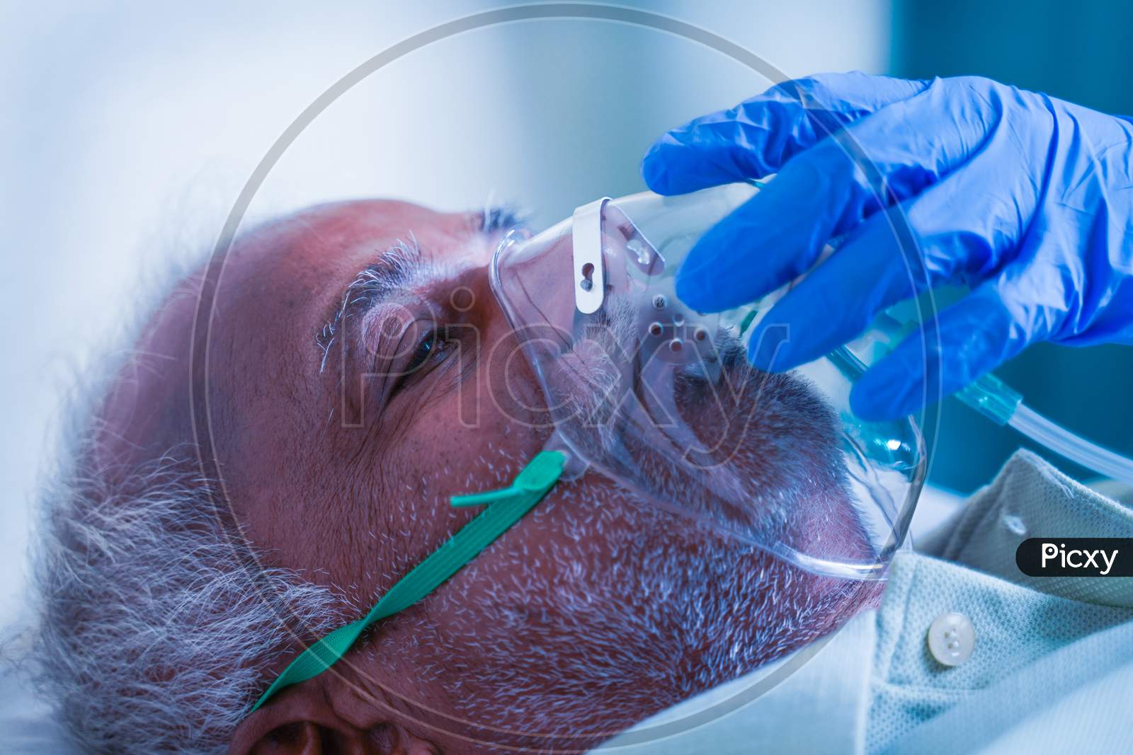 Close Up Shot, Doctor Helping By Adjusting Ventilation Oxygen Mask To Covid Infected Difficulty In Breathing Or Breathlessness To Patient At Hospital - Concept Of Dyspnea Due To Coronavirus Infection