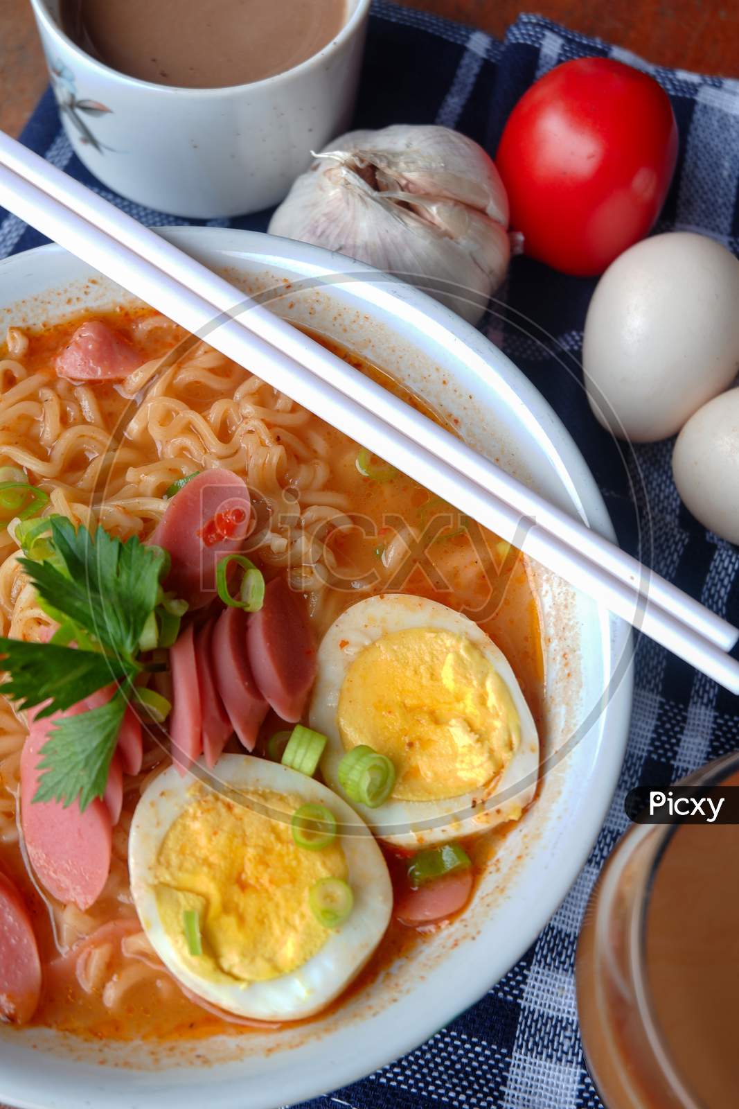 Photo Of Noodle Soup With Toppings Such As Sausages, Eggs, And Vegetables