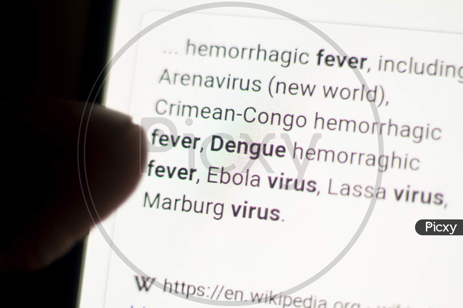 Dengue News On The Phone.Mobile Phone In Hands. Selective Focus And Chromatic Aberration Effects.