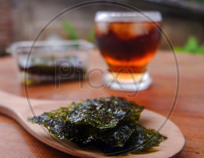 Photo Of Chopped Seaweed And A Cup Of Coffee And Mangosteen Beside It, A Photo Of The Meaning Of The Drink