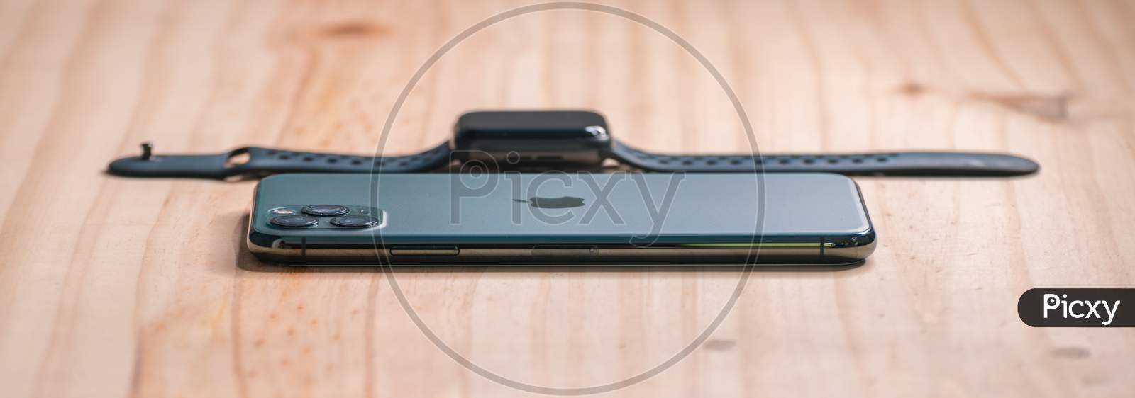 Galle, Sri Lanka - 02 19 2021: Apple Iphone 11 Pro Max And Apple Watch Series 6 Lay Flat On A Wooden Table With Low Angle Side View, Luxury And Lifestyle Concept.