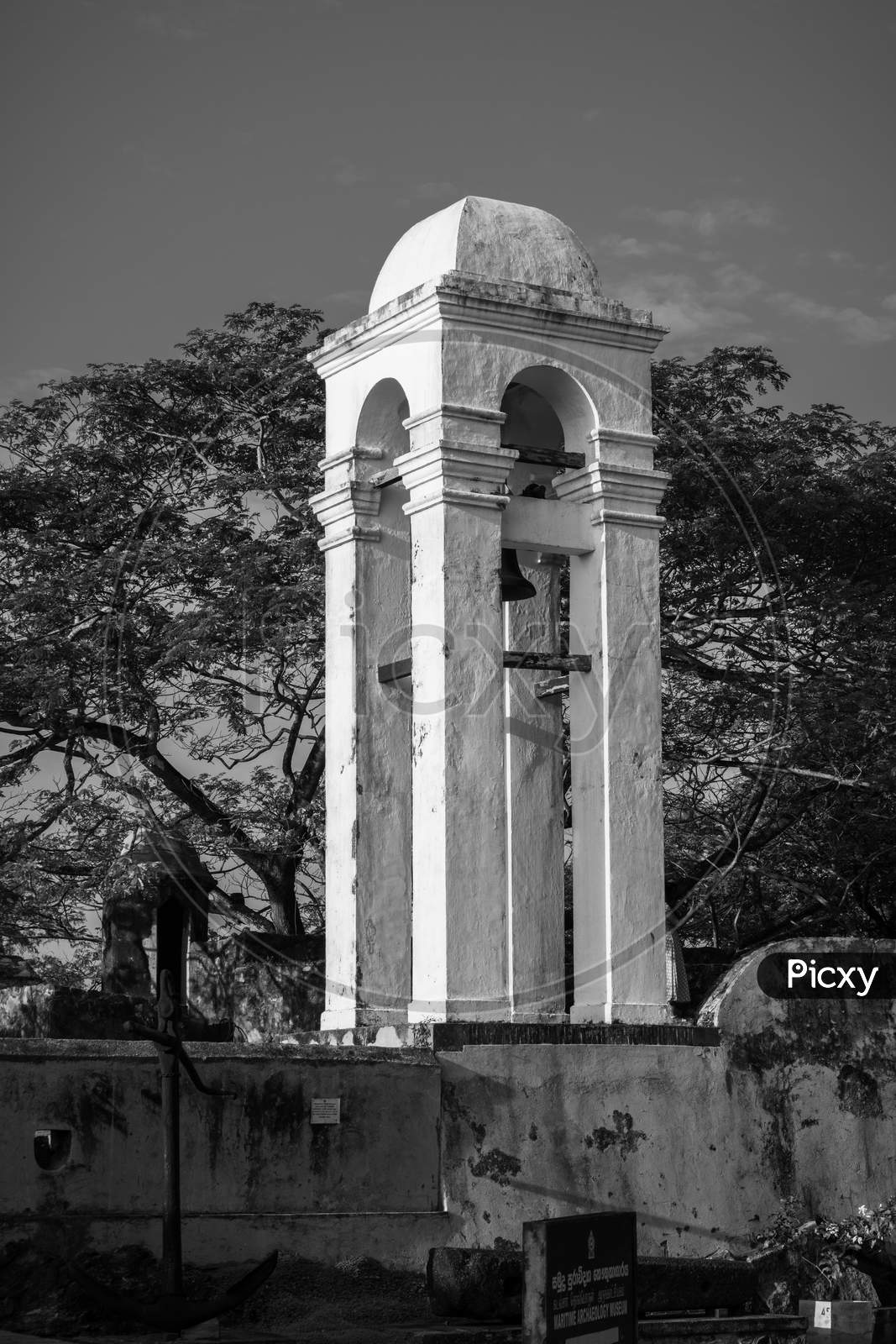 Tall White Bell Tower At The Maritime Museum In Galle Fort Black And White Photograph, Evening Bright Light Hits The Side Of The Tower.