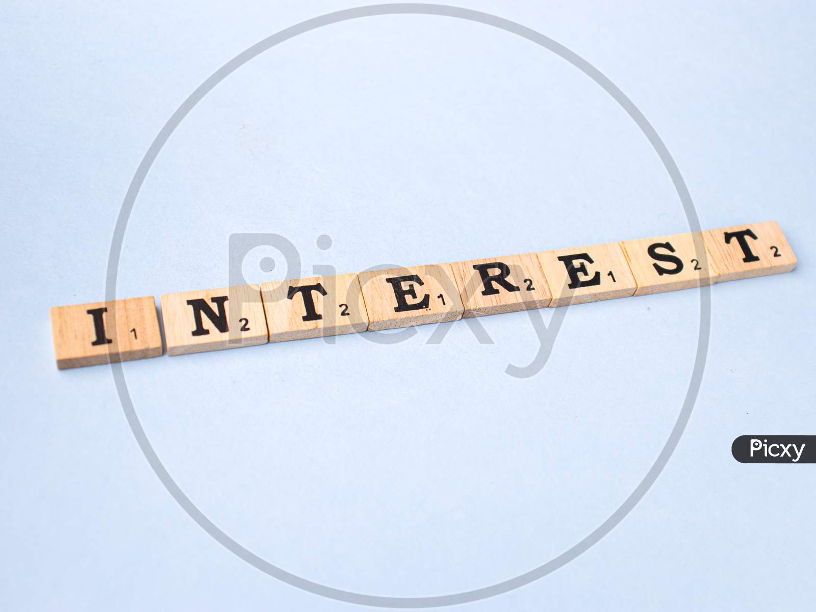 Assam, india - March 30, 2021 : Word INTEREST written on wooden cubes stock image.