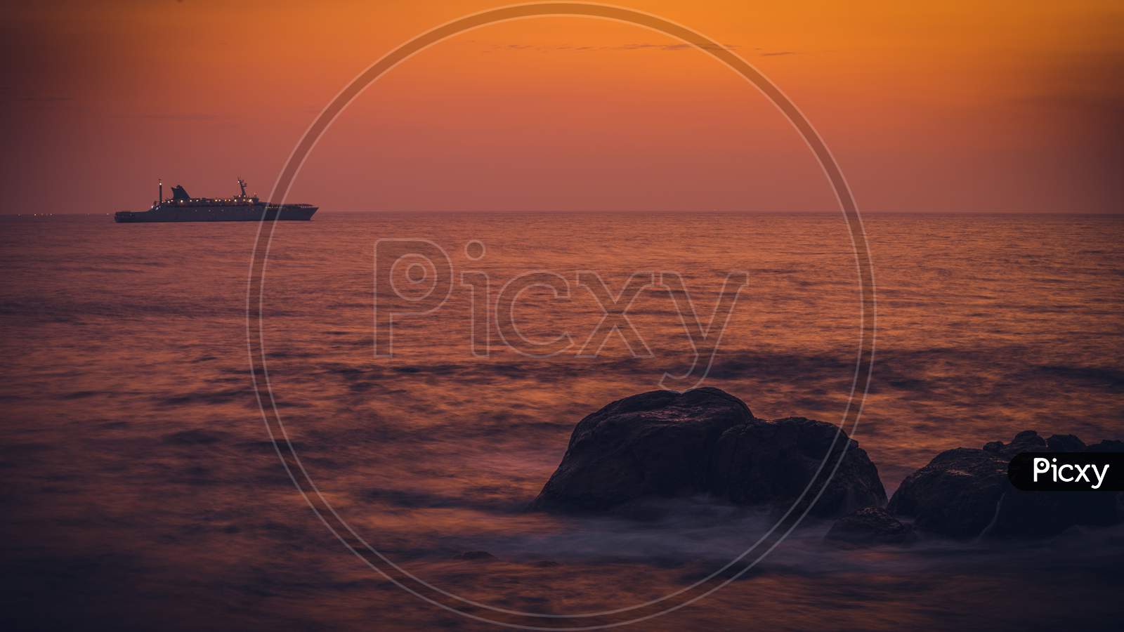 Colorful Sunset View From Galle Dutch Fort Evening, Sailboat In The Horizon, After Sundown Bright Orange And Yellow Skies, Long Exposure Photograph.