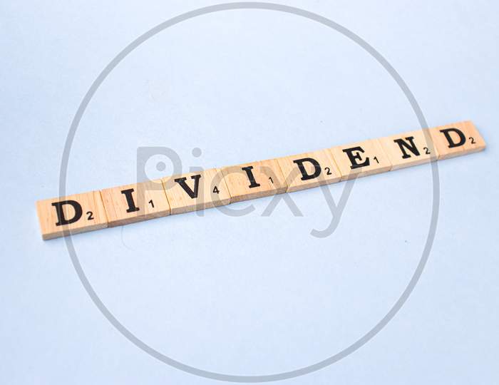 Assam, india - March 30, 2021 : Word DIVIDEND written on wooden cubes stock image.