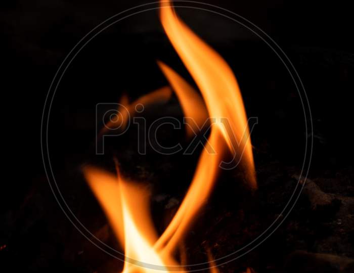 Vertical Fire Pattern Against Black Background Photograph.