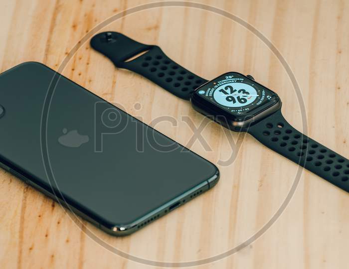 Galle, Sri Lanka - 02 19 2021: Apple Iphone 11 Pro Max And Apple Watch Series 6 Lay Flat On A Wooden Table, Luxury And Lifestyle Concept.