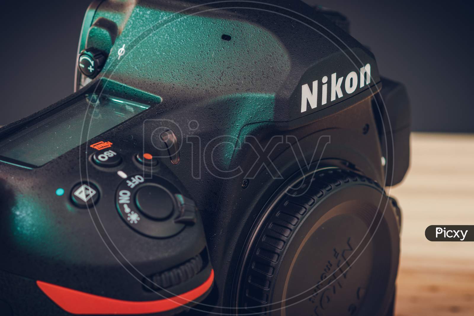 Galle, Sri Lanka - 02 17 2021: Nikon D850 Dslr Body With Camera Body Cap, Top Lcd Display, And Front Dials And On Off Switch Close Up. Modern Professional Camera Body On A Wooden Table View From Top.