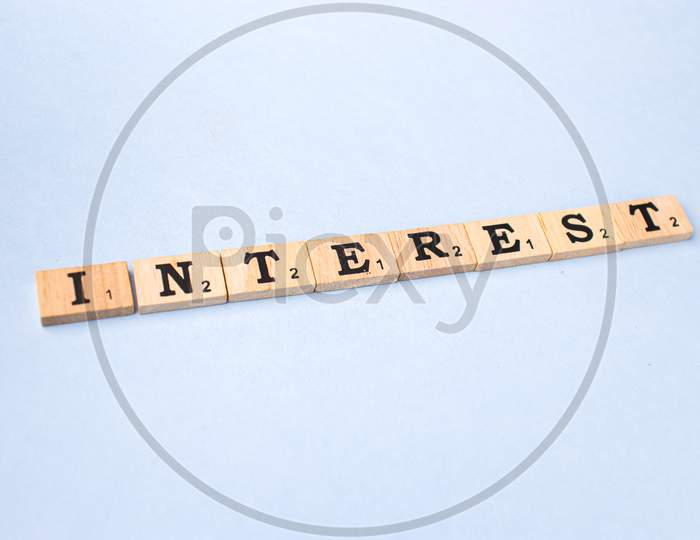 Assam, india - March 30, 2021 : Word INTEREST written on wooden cubes stock image.