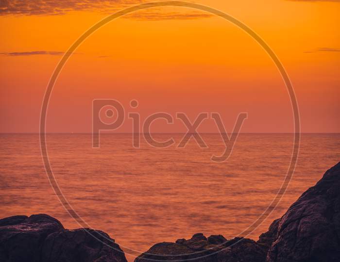 Colorful Sunset And Rock Formation In The Foreground With Waves Crashing View From Galle Dutch Fort Evening, After Sundown Blue Hour, Long Exposure Verticle Landscape Photograph.