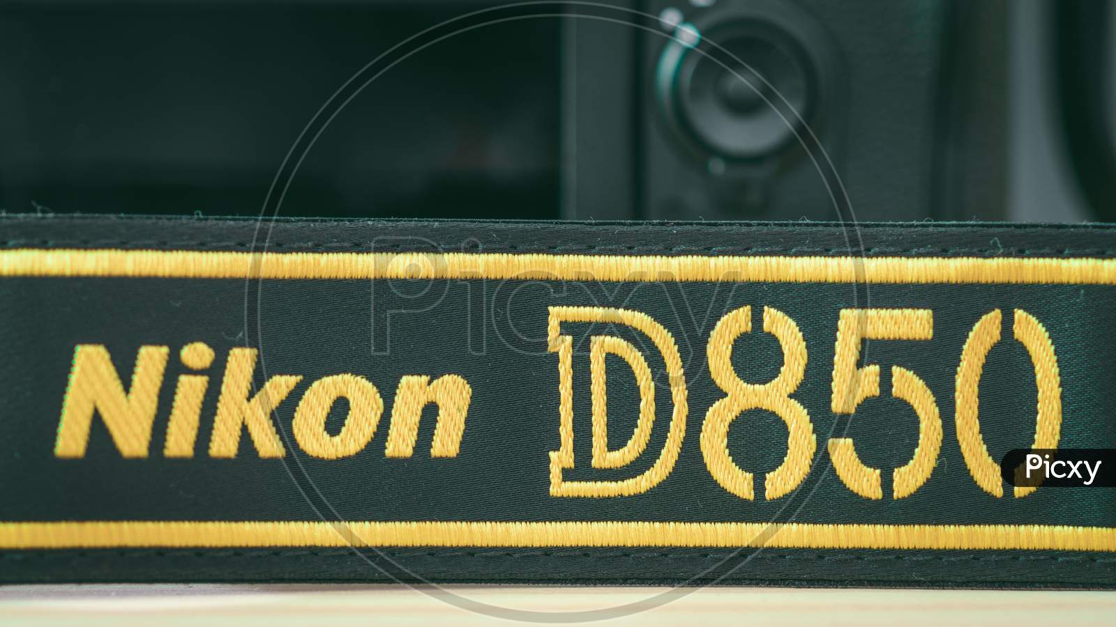 Galle, Sri Lanka - 02 17 2021: Nikon D850 Dslr And Camera Strap On Wooden Table Close Up, Brand New Nikon Logo Embroidered In Yellow Into A Black Ribbon, Professional Factory Finishing Product.