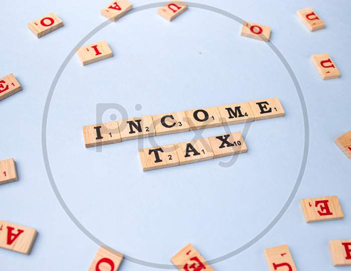Assam, india - March 30, 2021 : Word INCOME TAX written on wooden cubes stock image.
