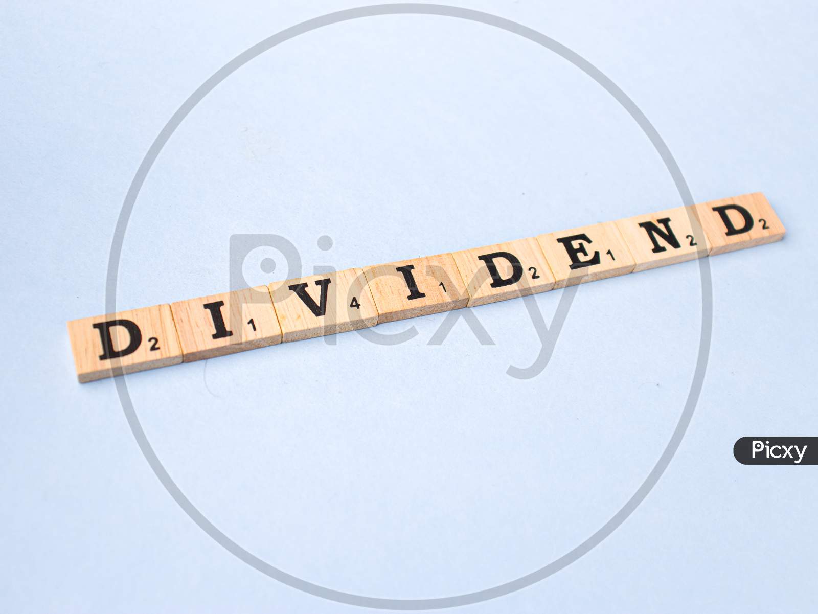 Assam, india - March 30, 2021 : Word DIVIDEND written on wooden cubes stock image.