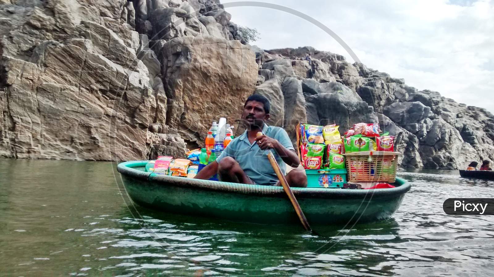 A vendor selling food items in Boat at a tourist place