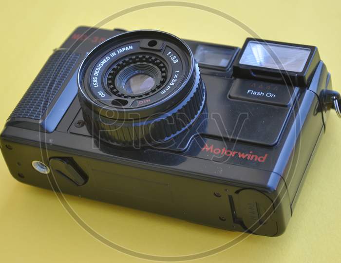 Mandi, Himachal Pradesh, India - 04 24 2021: Photo of a Yashica film roll camera MD-35f isolated over yellow background