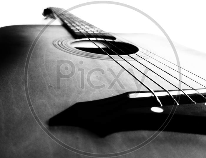 Black and white Acoustic Guitar on white background and space for text