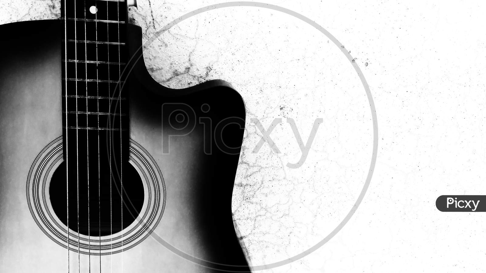 A silhouette photograph of a acoustic guitar with space for text