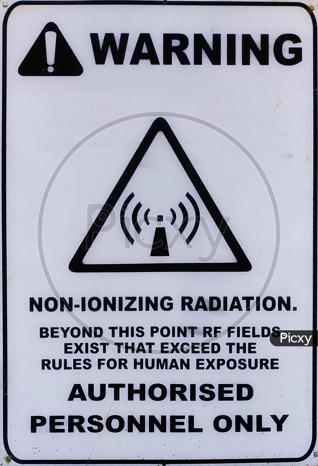 Non-ionizing radiation hazard safety area, danger warning text sign sticker label, large icon signage, isolated black triangle over white, macro closeup  K