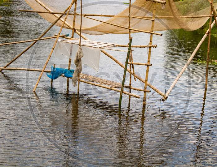 Fishing Nets Made Of Bamboo. A Beautiful River View Of Bangladesh. Fishermen Fish In The River To Get Nets.
