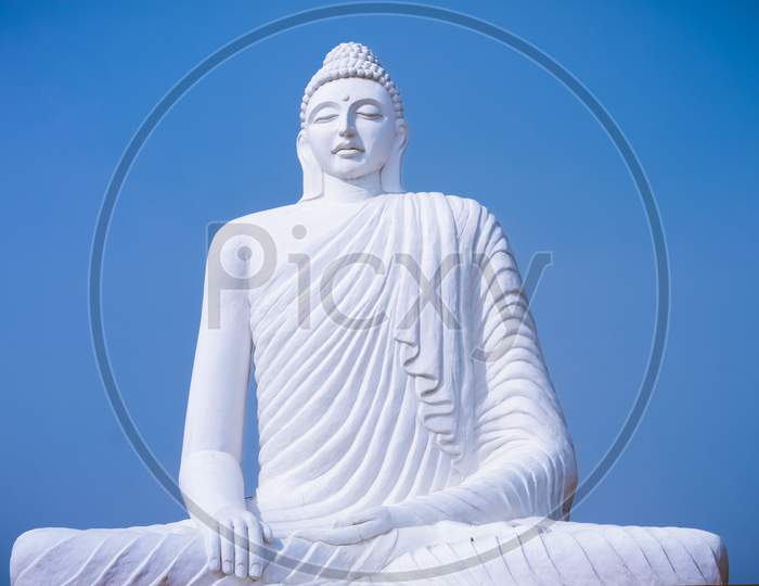 Close Up of an idol of Gautam Buddha, blue sky on the background, Statue of buddha, Religious, Buddhism.