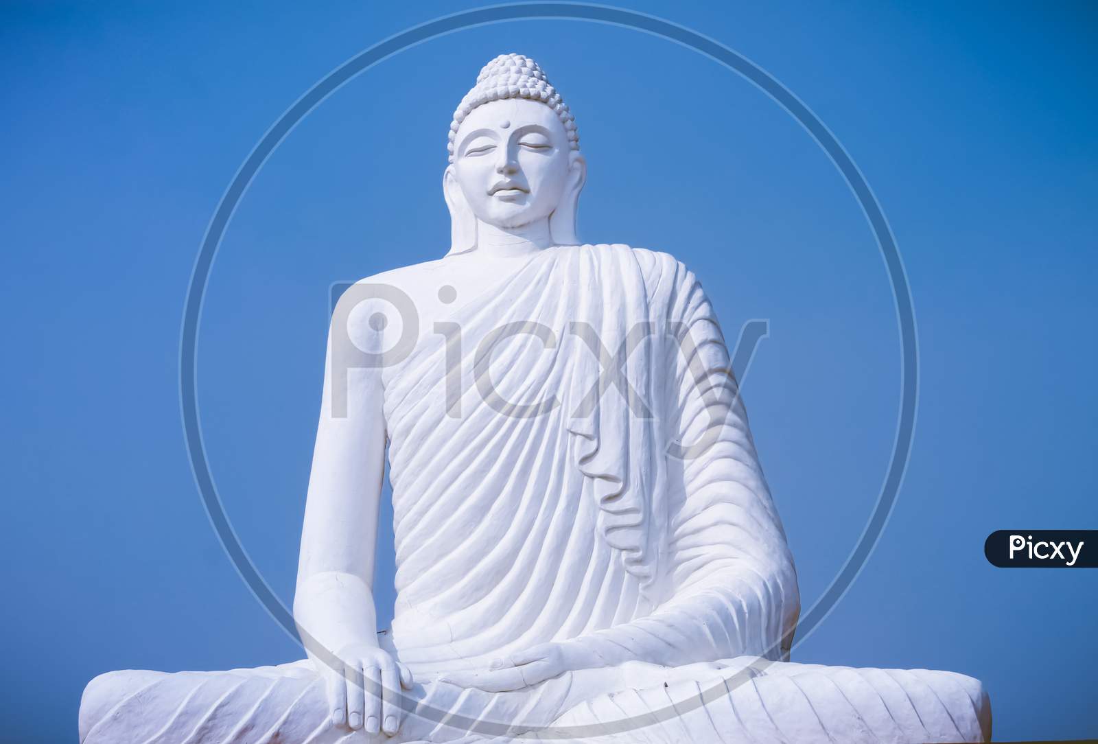 Close Up of an idol of Gautam Buddha, blue sky on the background, Statue of buddha, Religious, Buddhism.