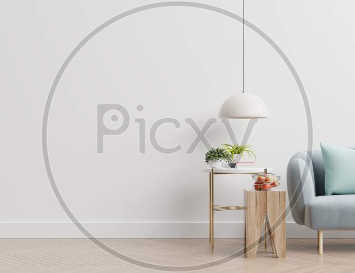 Empty Living Room With Blue Sofa, Plants And Table On Empty White Wall Background.