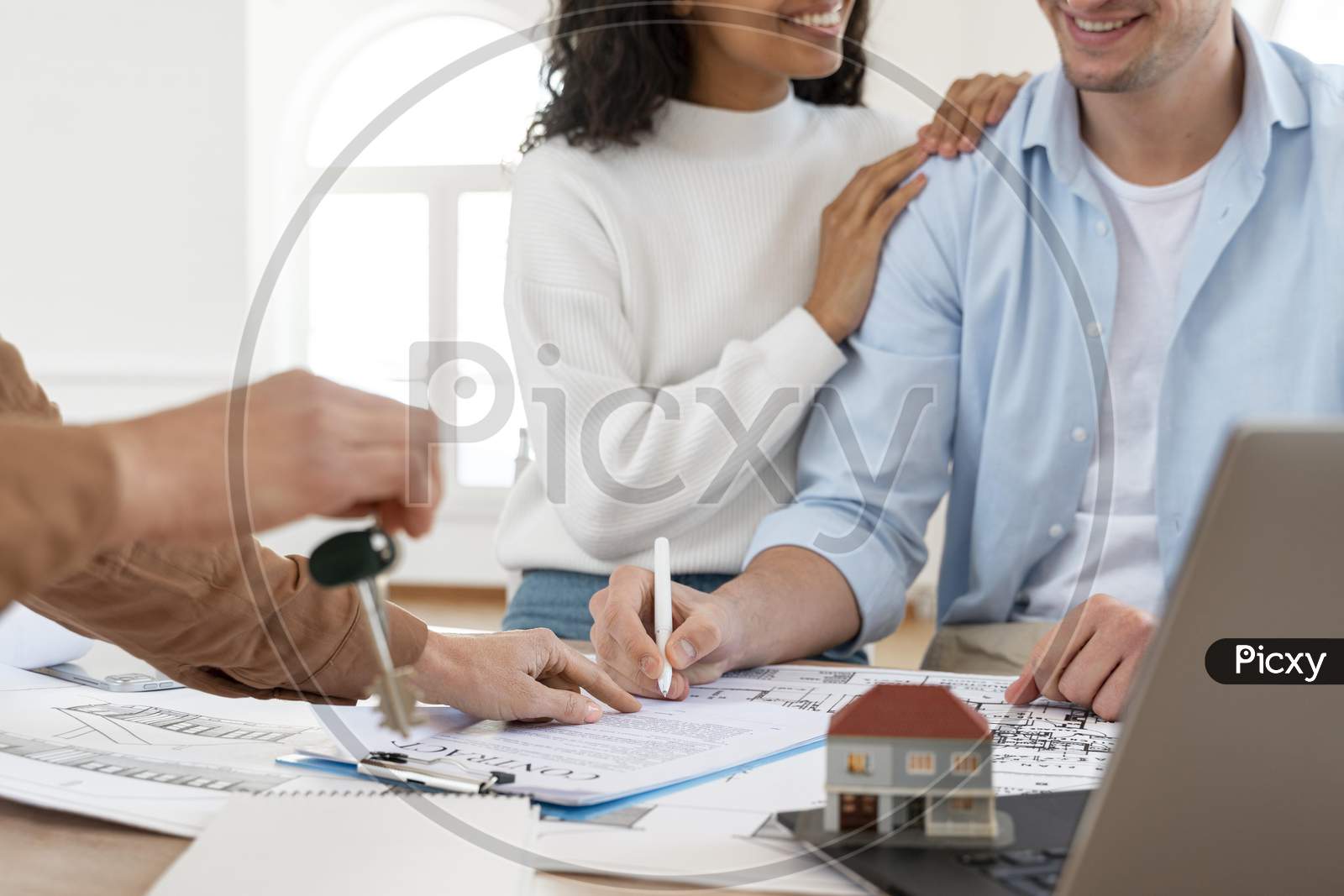 smiley couple signing contract new house